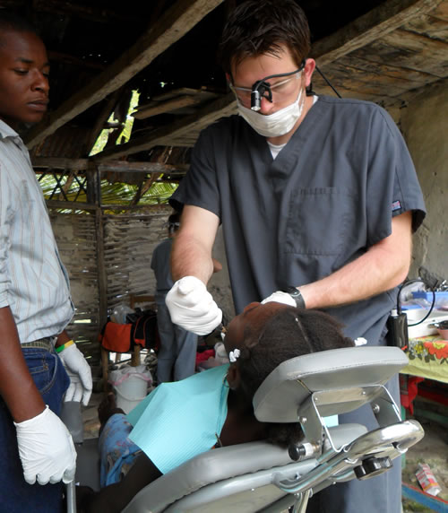 Dr. Green performing dental care on a patient in Haiti