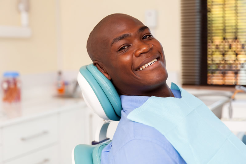 Young man smiling before tooth extraction surgery