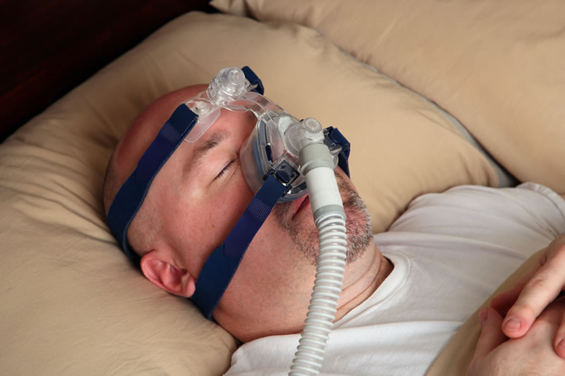 man sleeping with cpap mask
